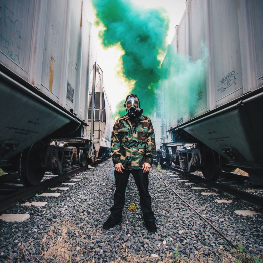 Alex from AG Flux Music Standing Between Two Trains